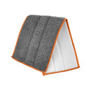 Close-up of a grey microfiber mop pad with white underside and orange border, folded to show texture.
