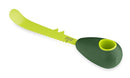 Kuhn Rikon green 3-in-1 avocado knife with serrated blade, pit remover, and scooping tip, displayed on a white background.