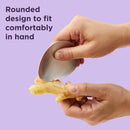 Green oval-shaped Chef'n garlic grater with a stainless steel grating surface.