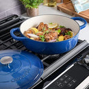 Blue enameled braiser on a stovetop, filled with braised meat and vegetables, ready to serve.