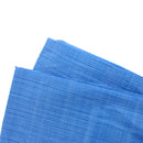 Blue heavy-duty poly tarp in its original packaging. The label highlights features like double laminated coating, extra strength weave, sun and fade resistance, rot and rust-proof material, and heat-sealed seams. The tarp measures 12' x 16' and is ideal for covering construction sites, farm equipment, machinery, trucks, boats, and more.