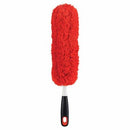 OXO Good Grips hand duster featuring a washable red microfiber head designed to attract and trap dust.