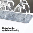 Light gray rectangular silicone drying mat with raised ridges for efficient drying.
