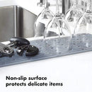 Light gray rectangular silicone drying mat with raised ridges for efficient drying.