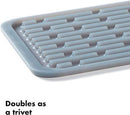 Light gray rectangular silicone drying mat with raised ridges for efficient drying.