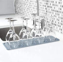 Light gray rectangular silicone drying mat with raised ridges for efficient drying.