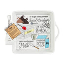 A white ceramic square baking dish with two side handles. The interior is printed with a hand-drawn chocolate fudge recipe and comes with a small silver metal serving utensil.