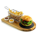 Yukon Glory Burger Serving Set, featuring a wooden board with a metal fry basket, two ceramic ramekins for sauces, and a burger on a round black coaster.