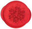 Red Nordic Ware reversible pie top cutter with apple design on one side and leaf design on the other, shown on a white background.