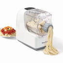 A white Starfrit electric pasta maker extruding long strands of fresh pasta. The machine has a clear top allowing a view of the dough inside. To the left, a white plate of cooked spaghetti with tomato sauce and shrimp is shown as a serving suggestion.