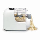 A white Starfrit electric pasta maker extruding long strands of fresh pasta. The machine has a clear top allowing a view of the dough inside. To the left, a white plate of cooked spaghetti with tomato sauce and shrimp is shown as a serving suggestion.