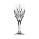 A set of four elegant crystal cut glass wine goblets with a diamond-cut pattern. One goblet is filled with red wine, while the others are empty, showcasing the intricate design and stem.