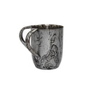 A metal washing cup (Netilat Yadayim) with a swirling black and silver marbled or distressed finish and a large loop handle.