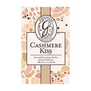 A product image of a "Greenleaf Cashmere Kiss Scented Envelope Sachet." The sachet packaging has a light background with a pattern of irregular, organic shapes in various shades of pink, orange, and brown. A central rectangular label, outlined in dark brown, displays "Greenleaf" in a stylized "G" logo at the top, with "Established 1975" underneath. Below the logo, "CASHMERE Kiss" is written in large, elegant brown script. Further down, it reads "Scented Envelope Sachet Sachet Parfumé" and ".68 cu.in. 11.09 