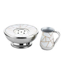 A Godinger Mayim Achronim set featuring a white and gold abstract patterned cup and a silver-toned stainless steel bowl.