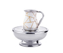 A Godinger Mayim Achronim set featuring a white and gold abstract patterned cup and a silver-toned stainless steel bowl.