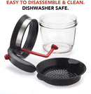 Clear fat separator with black handle and strainer, and a red stopper inside.