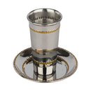 Small silver stainless steel Kiddush cup and saucer with shiny gold beaded base, displayed on a white background.