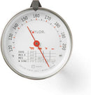 Taylor brand classic style meat thermometer featuring a round dial with Fahrenheit markings from 120 to 200 degrees. The dial face includes icons for beef, pork, poultry, and lamb/veal, along with recommended temperatures for different levels of doneness. The thermometer has a stainless steel probe and a clip for oven use.