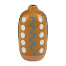 A medium, cylindrical stoneware bud vase with a tan speckled glaze, featuring a hand-painted white dot and blue squiggle line pattern, and an exposed terracotta base.