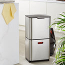 A two-tiered stainless steel trash and recycling bin with a black lid and base. The top compartment has a small, horizontal orange light on its front.