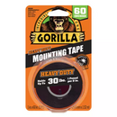 Orange and black packaging for Gorilla Heavy Duty Mounting Tape featuring a gorilla illustration. The tape itself is visible, a black double-sided adhesive roll that is 60 inches long and can hold up to 30 lbs (1 pound per 2 inches).