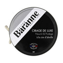 A round tin of Maison Baranne Cirage De Luxe shoe polish, with a black and white label indicating "Nourrit & Protège à la cire d'abeille" (Nourishes & Protects with beeswax) and "Fabrication Française" (French Made), in black color.