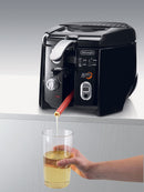 A black and silver De'Longhi deep fryer with a rounded design. The front panel features a control knob, a viewing window, and an "Easy Clean" button. The lid has a ribbed texture and a handle is visible on the side. The "ROTO FRY" logo is prominent on the front.