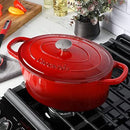 Red enameled 7-quart cast iron Dutch oven with matching lid.