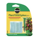 A package containing several light blue fertilizer spikes and one green plastic insertion tool, designed for feeding indoor flowering and foliage houseplants.