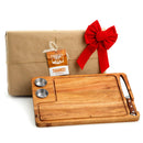 Three stacked Yukon Glory Premium Acacia Wood Steak Boards, each with two stainless steel sauce cups and a slot for a knife.