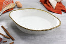 Pampa Bay oval baking dish in white, accented with a bright gold beaded border for a touch of elegance.