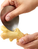  Green oval-shaped Chef'n garlic grater with a stainless steel grating surface.