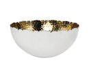 Godinger Munro white ceramic fruit bowl that has a simple, rounded, and slightly shallow shape. The Rim is irregularly shaped with hand-hammered gold interior.