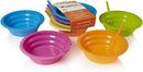 A set of colorful collapsible silicone bowls in blue, pink, orange, and lime green with straws