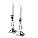 wo Classic Touch candle holders are displayed against a white background. Each holder features a silver-toned circular top designed to hold a taper candle, a faceted crystal glass stem with a twisted design, and a square silver-toned base. A white taper candle is placed in each holder. The overall height of each holder is approximately 4.75 inches.