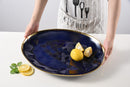 Lemons on an Oversize serving platter with sunset design and titanium finish 