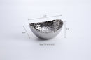 A medium-sized, oval serving bowl with a shiny silver color and a distinctive hammered texture on the entire surface.
