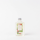 A clear glass bottle of Greenleaf Merry Memories scented reed diffuser oil. The label features the Greenleaf logo above the scent name "Merry Memories" in red script, with "Spiced Pear" below in smaller text. The label also has illustrations of red berries and green leaves. The bottle has a silver cap.