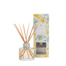 Bella Freesia 4oz reed diffuser in a clear glass container with fiber reeds on a white background.