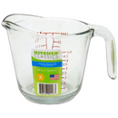 Glass measuring cup from the Kitchen Classics Mix & Measure collection, featuring red measurement markings in ounces, milliliters, and deciliters. The cup has a clear handle, a pouring spout, and a 500ml (16oz) capacity. Label includes a barcode, a USA flag, and a ‘2-cup’ indicator.