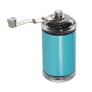 A manual coffee grinder with a clear top and bottom, featuring a vibrant turquoise blue body and a silver hand crank. The background is transparent.