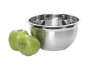 Next to two fresh, round green apples sits a YBM HOME 0.75qt Professional Mixing Bowl. The bowl features a reflective, shiny surface, enhancing the composition's suggestion of kitchen or cooking preparations.