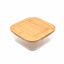 A square glass food storage container with a natural bamboo lid.