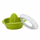 A two-piece green plastic manual citrus juicer. The juicer's reamer and bowl are a vibrant green, and the separate, clear plastic top strainer is propped up next to it.