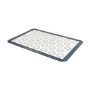 A rectangular Chicago Metallic silicone baking mat with a dark gray border and a white center featuring multiple concentric circular guides, ideal for macarons or cookies.