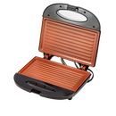 An open black electric indoor grill maker with copper-colored, non-stick grilling plates, suitable for making paninis or toasting bread.