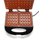 Zenith waffle maker with a black plastic body and orange Zera Copper nonstick grill plates, shown open on a white background.