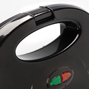 Zenith waffle maker with a black plastic body and orange Zera Copper nonstick grill plates, shown open on a white background.