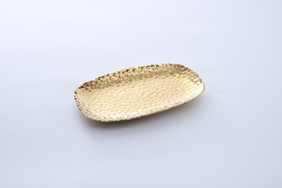 A top-down, slightly angled shot of a Pampa Bay Small Gold Serving Platter. The platter is rectangular with rounded corners and features a hammered, textured surface that gives it a dimpled appearance. Its edges are uneven and organic, and it has a shiny, reflective gold finish. The platter is positioned on a plain white or light gray background.